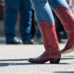 Closeup,Of,Woman,Legs,With,Red,American,Boots,At,Country